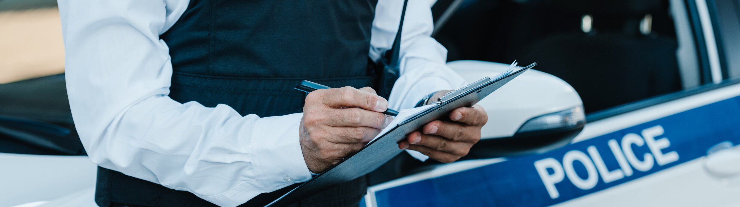 Police Officer Writing on Clipboard