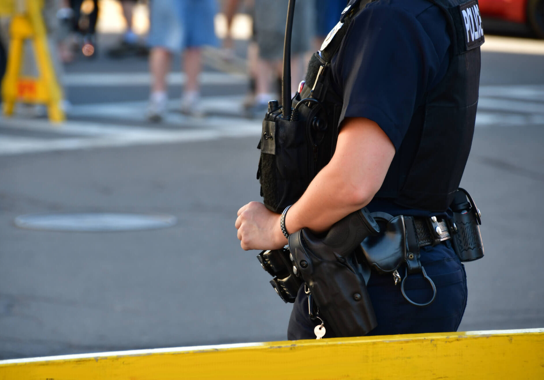 cropped view of female police officer standing guard